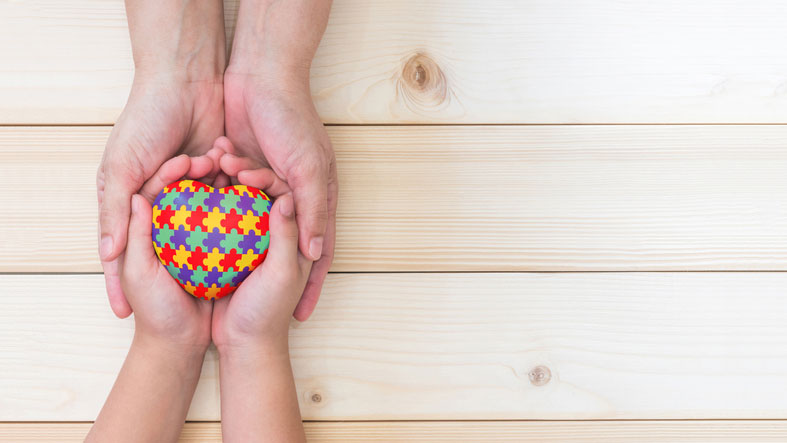 autistic puzzle heart in pair of hands