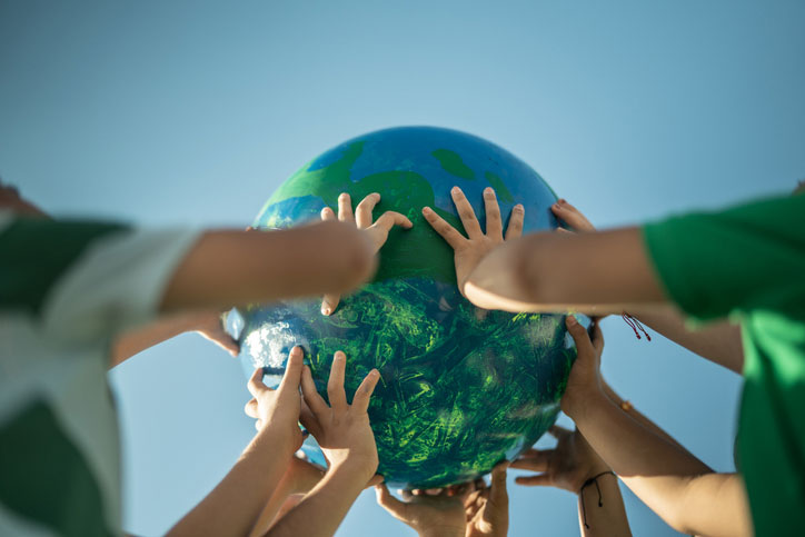 children holding up planet with their hands