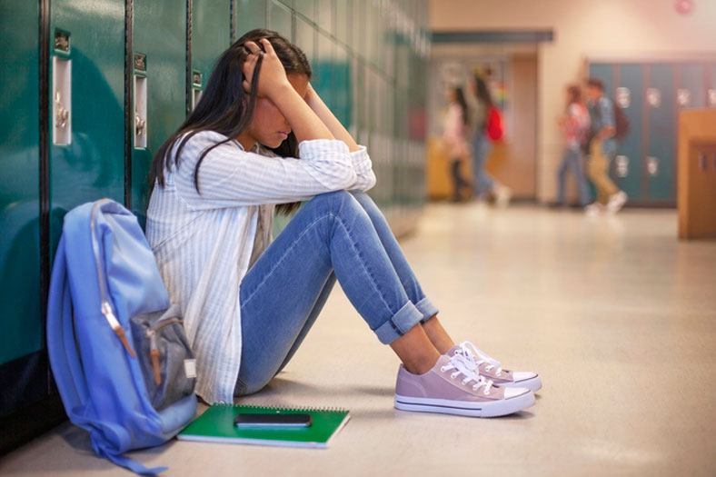 frustrated teen with head in hands