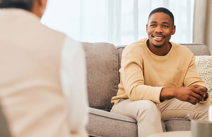 social worker talking with patient on sofa