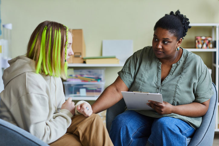 social worker talking with teen patient