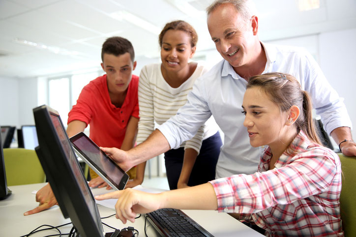 teacher and students learning on computer