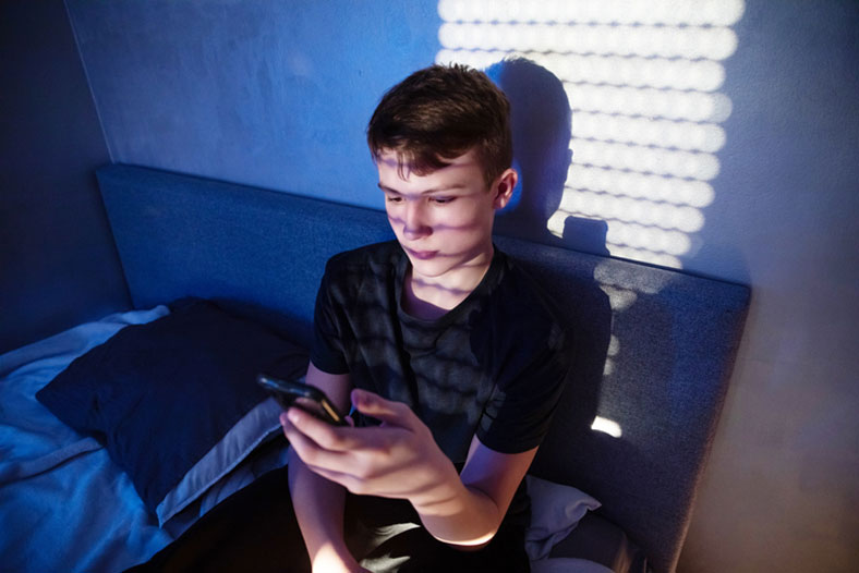 teen on cell phone at night