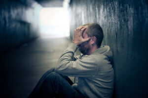 young homeless addict in tunnel